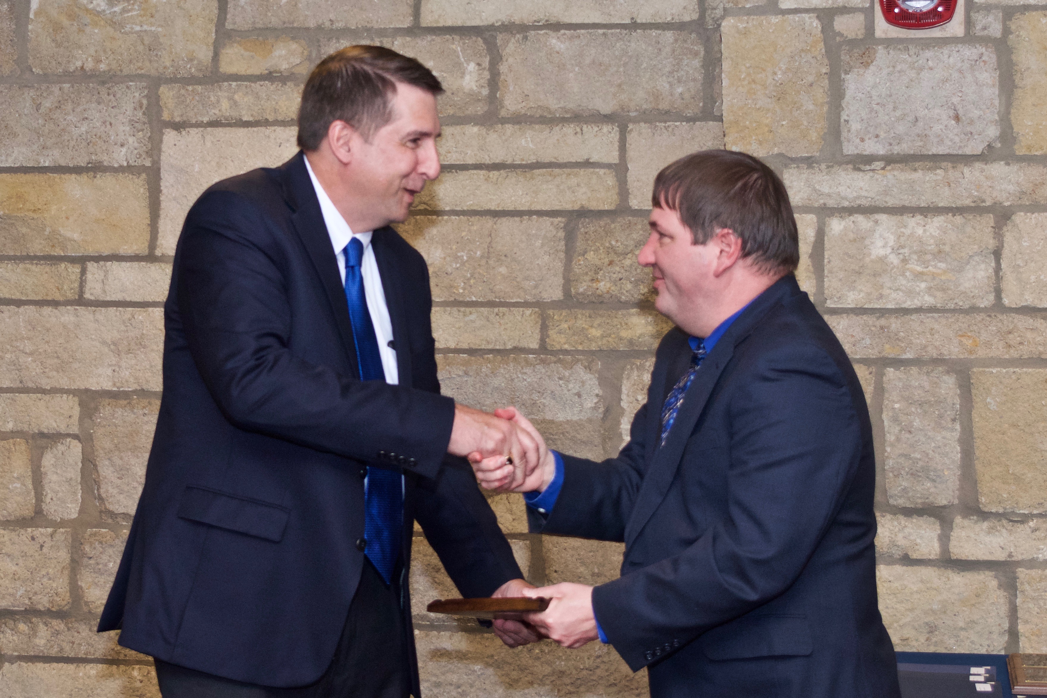 Associate Professor Kyle Camarda presenting Gary Gould his plaque at the 2017 Awards Banquet