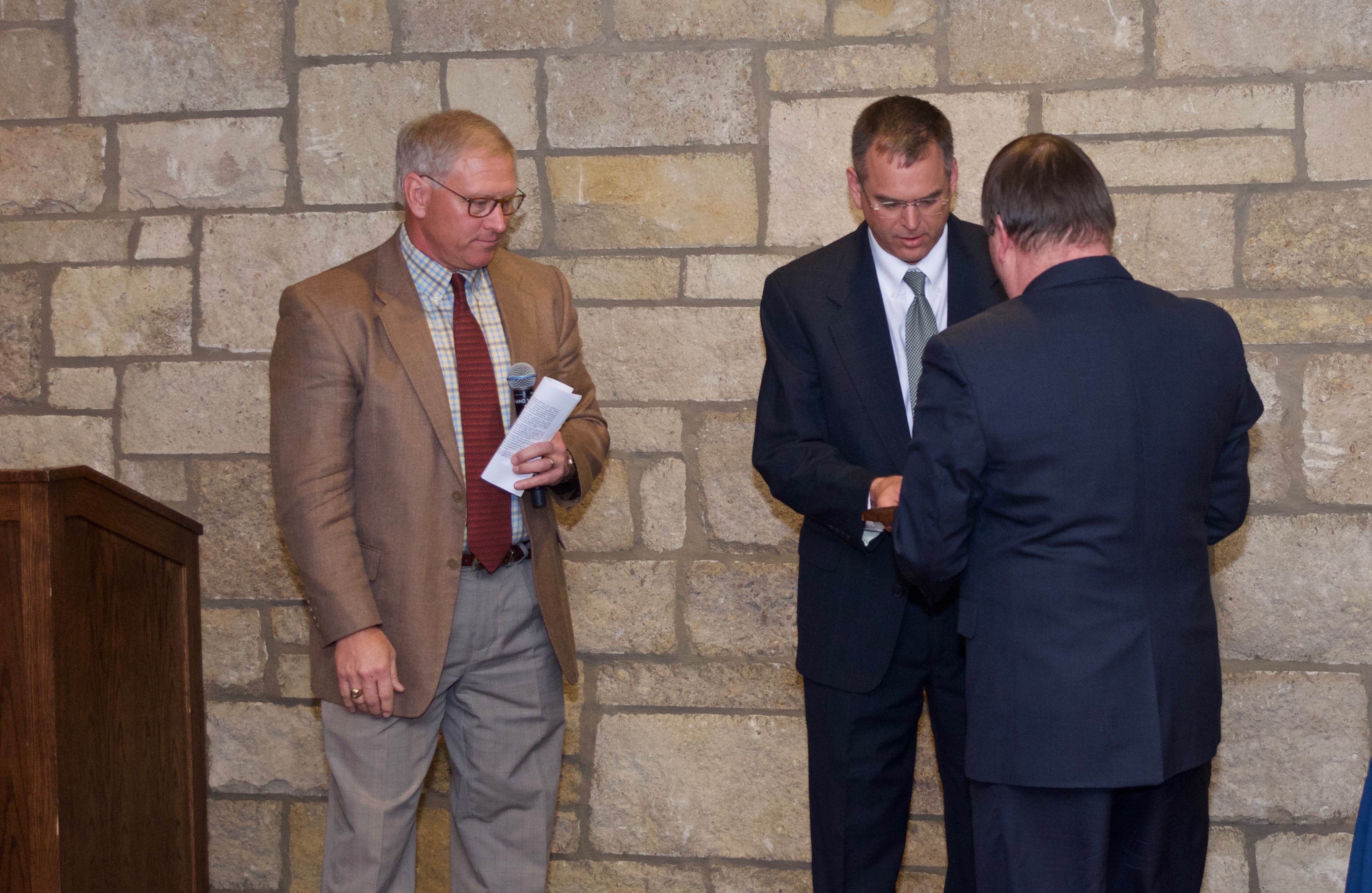 Dr. Guy Green receiving his plaque with Kyle Camarda and Lanny Schoeling