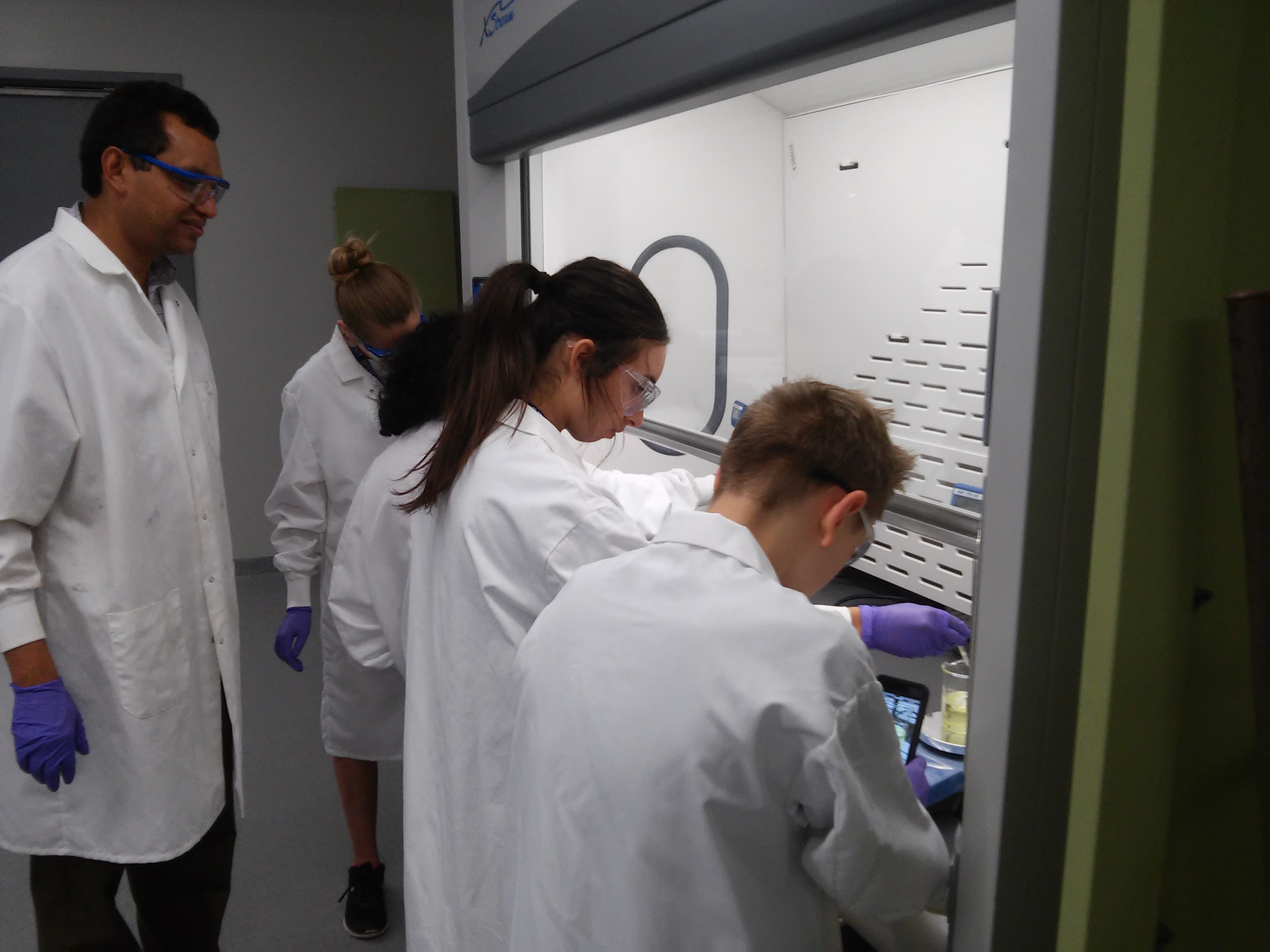 Juan Bravo pictured with four students in his lab