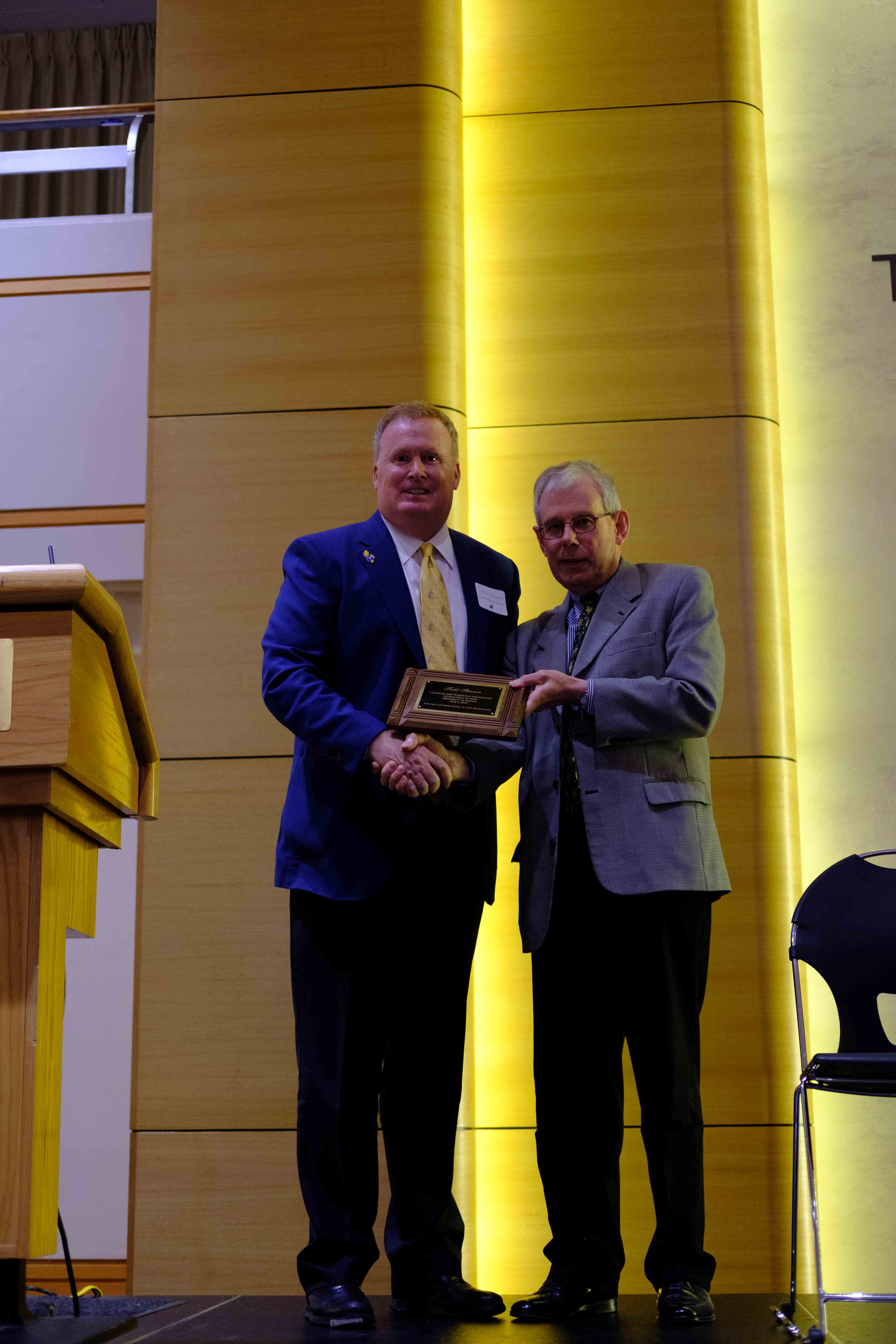 Todd Slawson receiving his Hall of Fame plaque from Dept Chair Laurence Weatherley