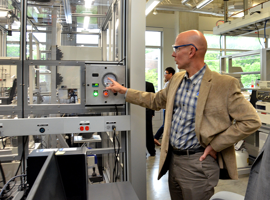 Mark Shiflett in his lab explaining equipment to unseen person