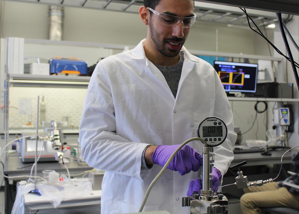 A student working with a piece of equipment in the lab
