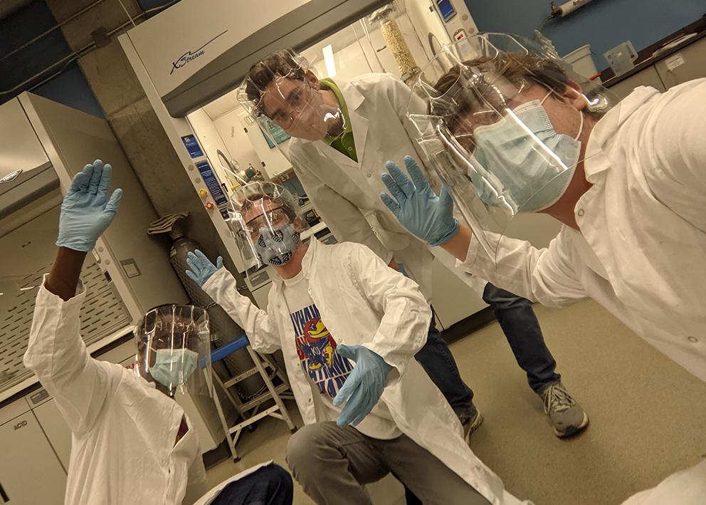 four seniors having fun in senior lab dressed in full PPE