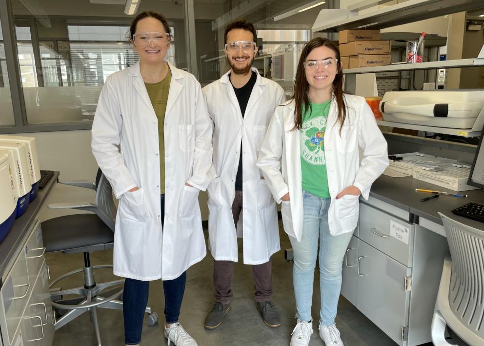 Three students posing for picture in the lab