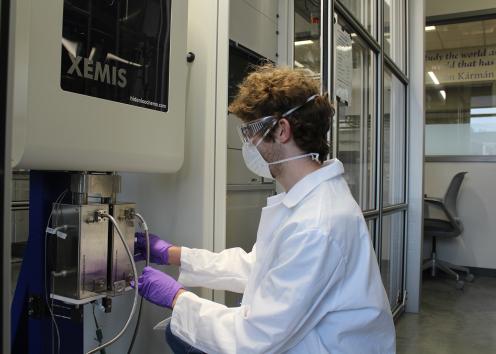 Graduate student Andrew Yancey working on the XEMIS machine in the Shiflett lab wearing PPE