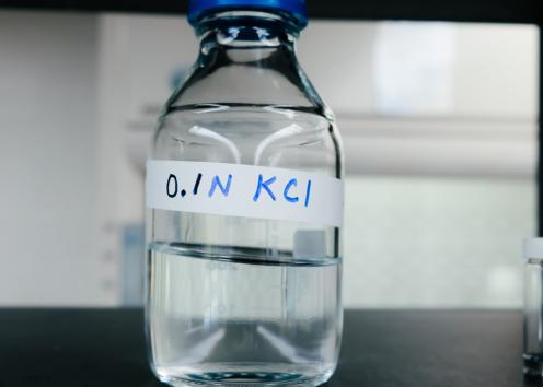 bottle containing clear fluid with the label 0.1 N KCI