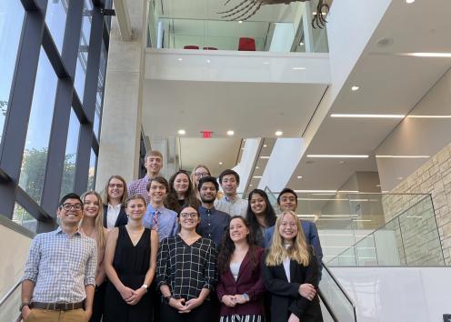 Fifteen REU participants standing on staircase in Slawson Hall auditorium