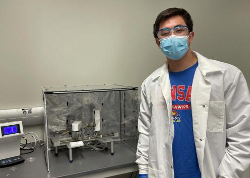 Student next to experimental apparatus