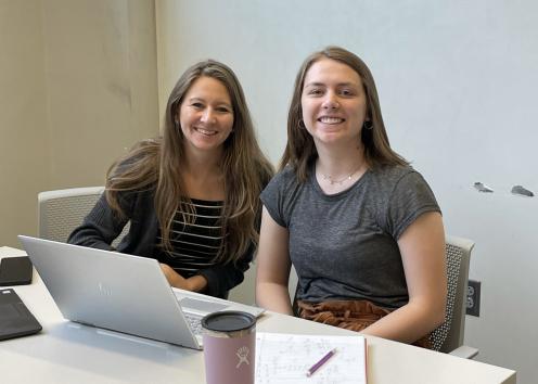 Two students at a table working