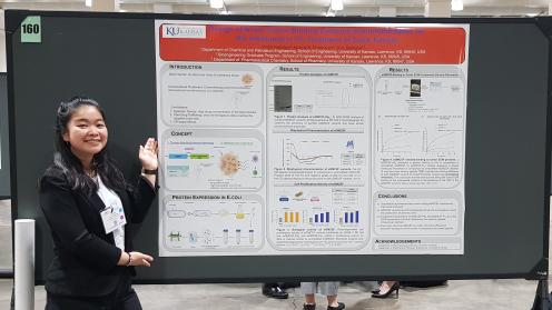 Vivian standing next to her research poster at the conference