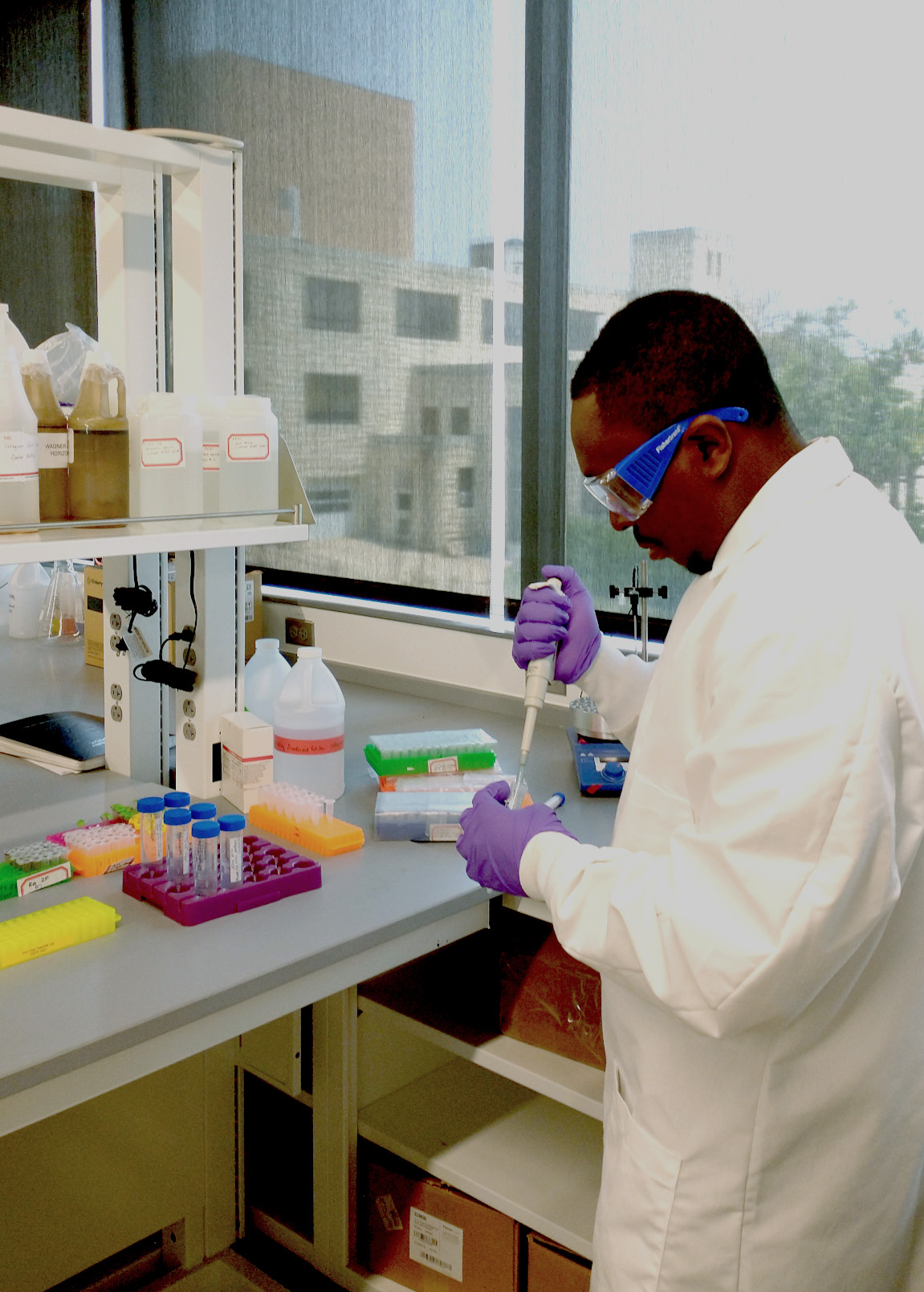 a student adds liquid to a vial with an eye dropper