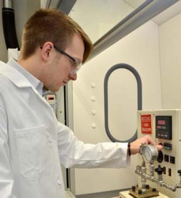 a researcher checks a gauge